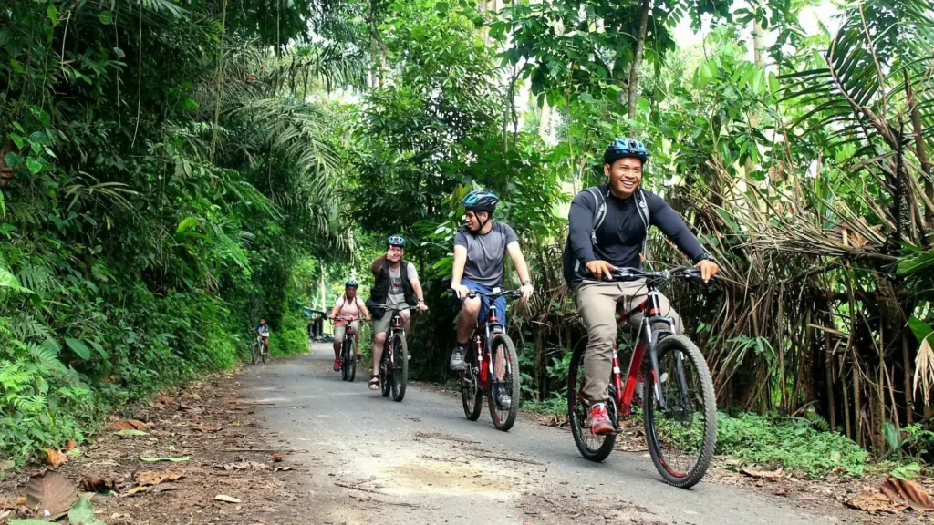 A local cycling guide with guest passing through the rural village